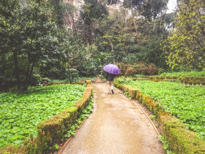 A person walking through Parc del Laberint d'Horta in Barcelona
