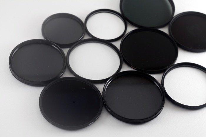 A flat lay of various lens filters for travel photography