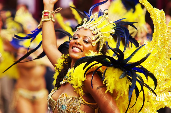 A portrait of a carnival dancer in flamboyant yellow feathered dress