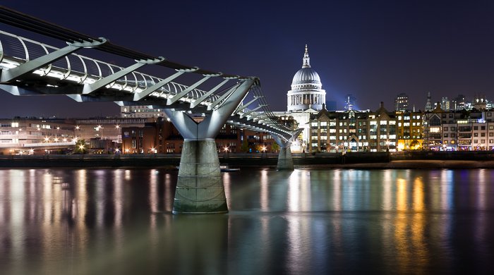 Stunning night cityscape with a river in the foreground