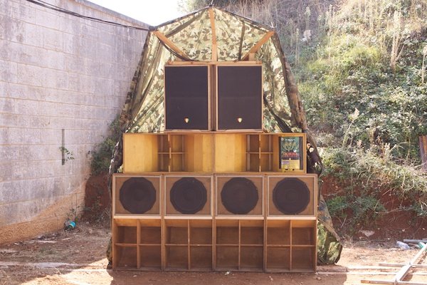 An artistic setup of speakers and cupboards in an outdoor location