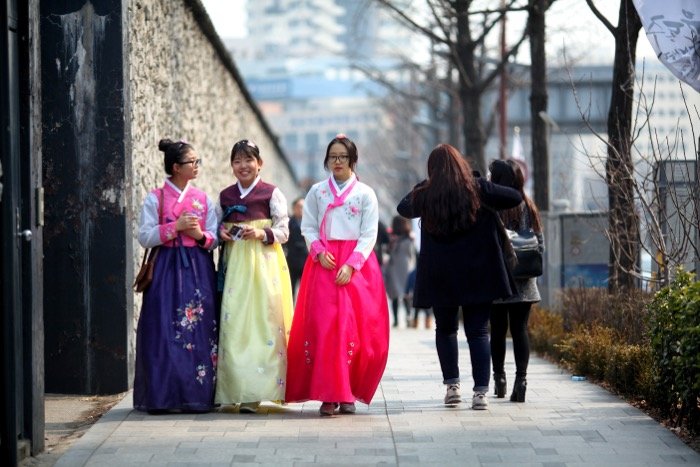street photography showing three South Korean girls wearing traditional clothing known as Hanbok