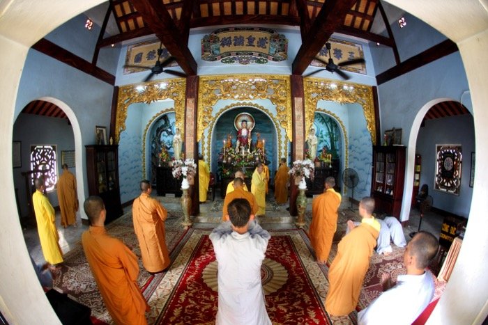keeping a respectful distance while photographing a traditional ceremony in a temple.