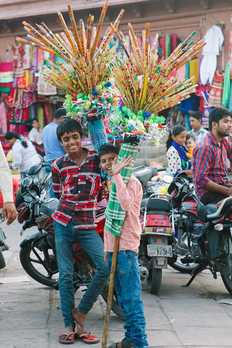 Travel photography of two boys smiling at the camera in India.