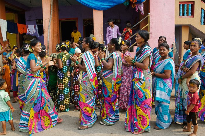 Travel photography of a group of colourfully dressed women on the streets in India.