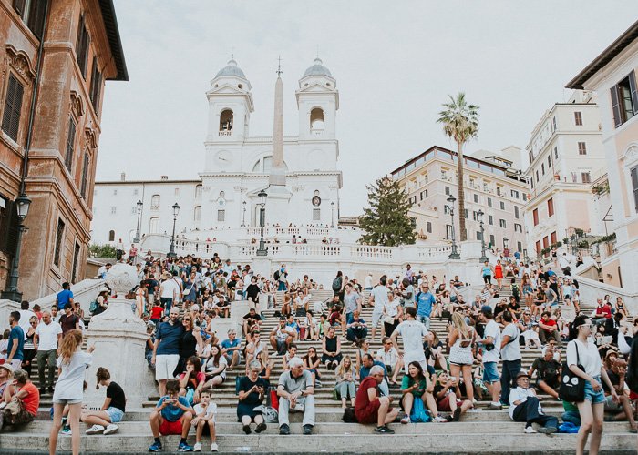 Travel photography of crowds of tourists in Rome.