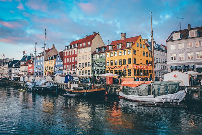 Coloured house and boats by the river in Copenhagen - most beautiful cities in the world