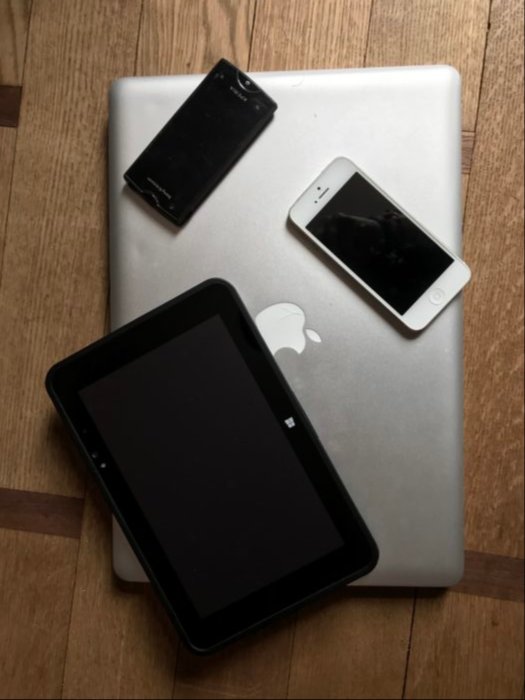 My 15" MacBook Pro compared with a Windows tablet 8", an iPhone 5 and a Sony Xperia Ray Android phone.