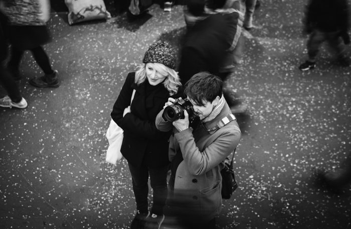 overhead shot of a couple taking street photos 