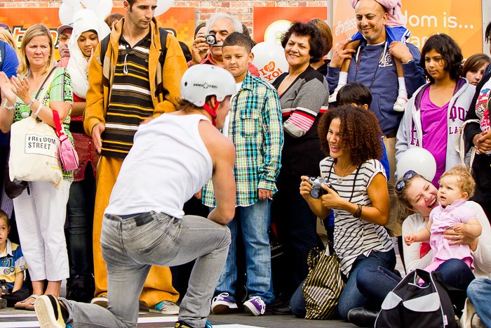 A man performing at the Thames Festival with a crowd watching