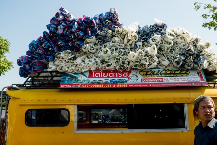 Documentary photography of a man in front of a yellow vehicle