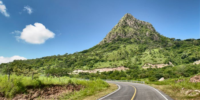 Driving through a luscious mountainous landscape 