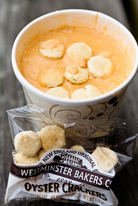 close up of crackers floating on foam in a cup of coffee