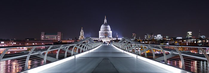 Cityscape view of St. Paul's Cathedral from the Millenium Bridge at night.